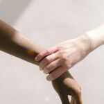 Close-up of diverse hands clasped together, symbolizing unity and support.